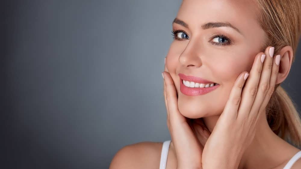 smiling woman enjoying in her healthy skin