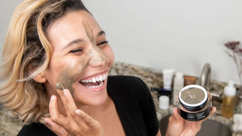 a woman is happy to use facial mask